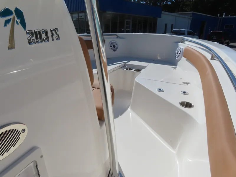 Slide: The Image of 2025 Key West 203 FS boat interior with tan seating and cup holders. - 9
