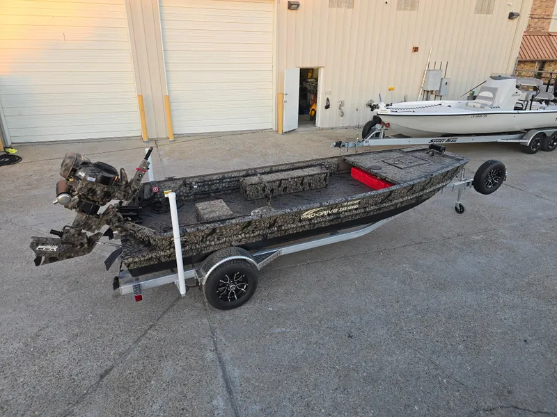 Slide: The Image of 2025 Pro-Drive SBX Series TD boat on trailer, parked outside industrial building. - 5