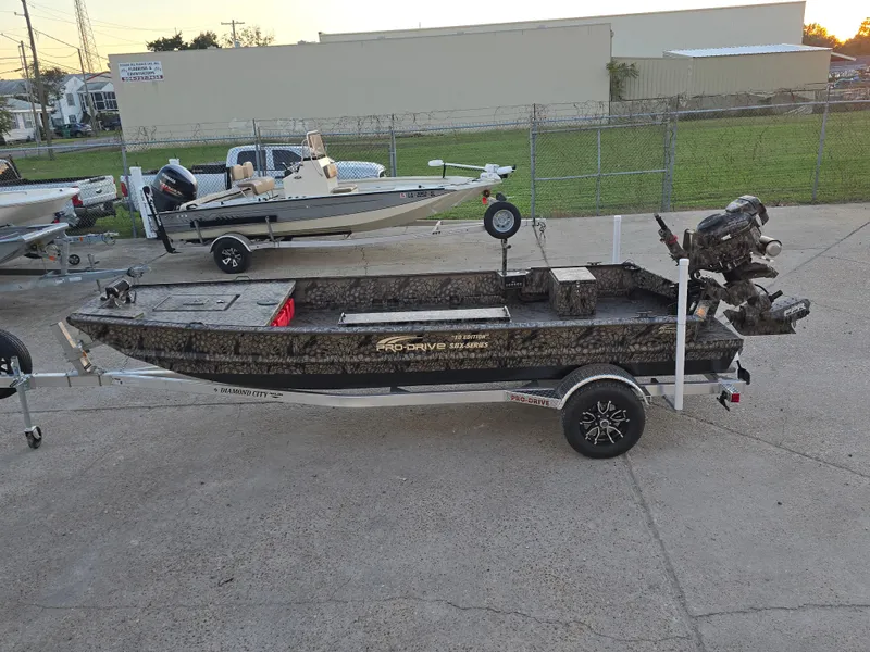 Slide: The Image of 2025 Pro-Drive SBX Series TD boat on trailer, parked outdoors. - 9