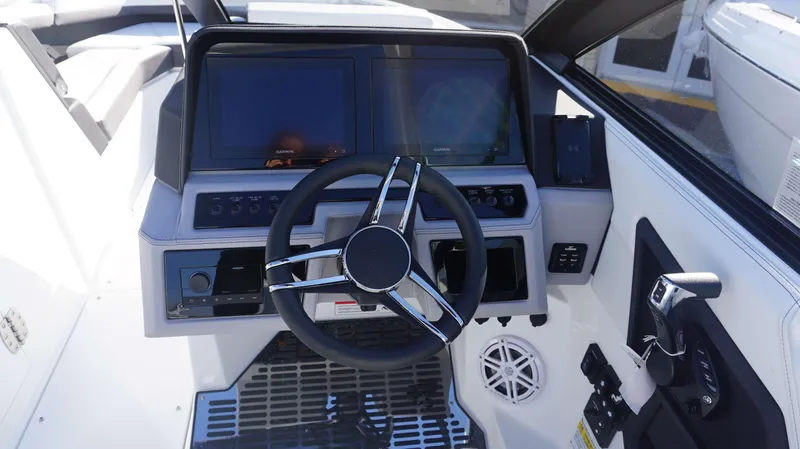 Slide: The Image of 2025 Cobalt R6 boat dashboard with steering wheel and dual screens. - 14