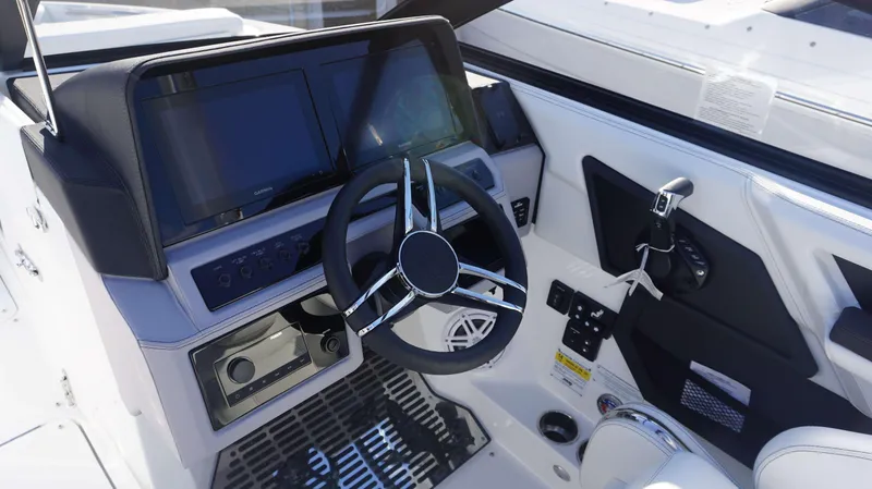 Slide: The Image of 2025 Cobalt R6 boat dashboard with modern steering wheel and digital displays. - 15