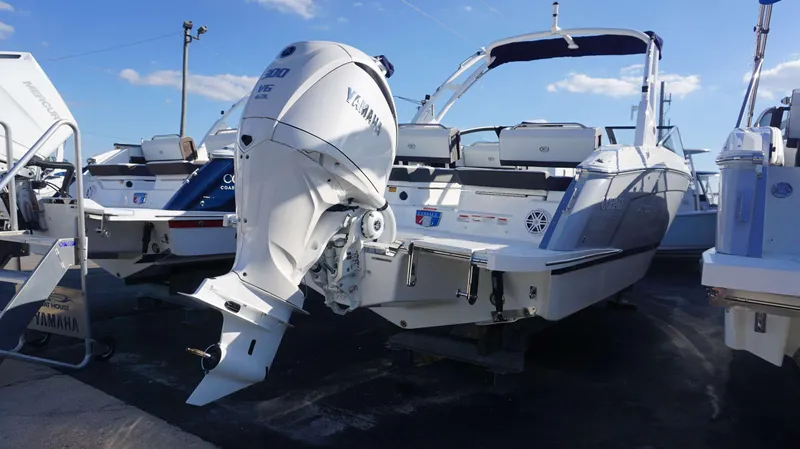 Slide: The Image of 2025 Cobalt R6 boat with Yamaha outboard motor, docked under clear blue sky. - 3