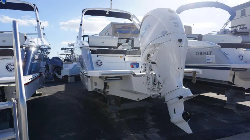 Slide: The Image of 2025 Cobalt R6 boat with powerful outboard motor, docked under clear skies. - 4