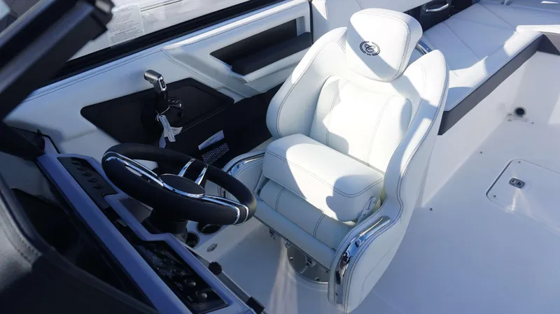 Slide: The Image of 2025 Cobalt R6 boat interior with white captain's seat and steering wheel. - 9