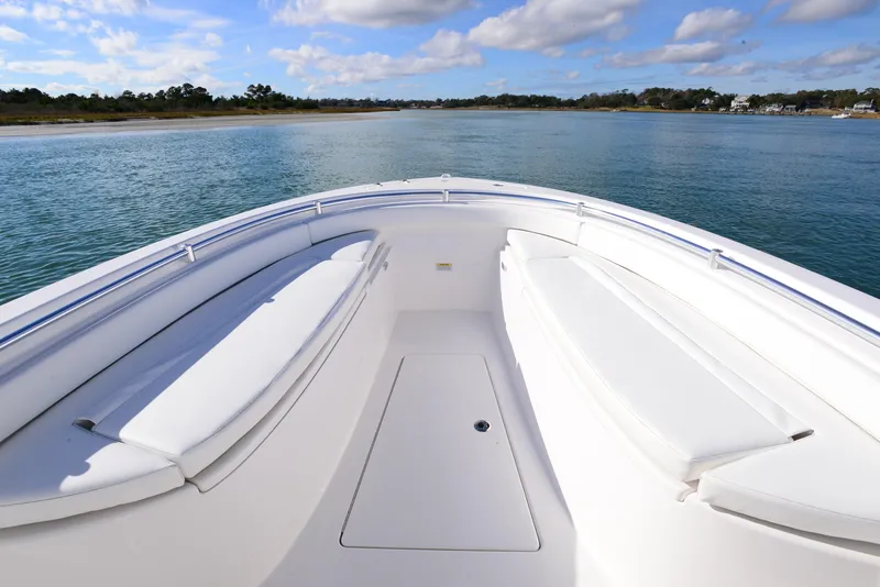 Slide: The Image of 2024 Contender 24 Sport boat with spacious seating on calm waters. - 16