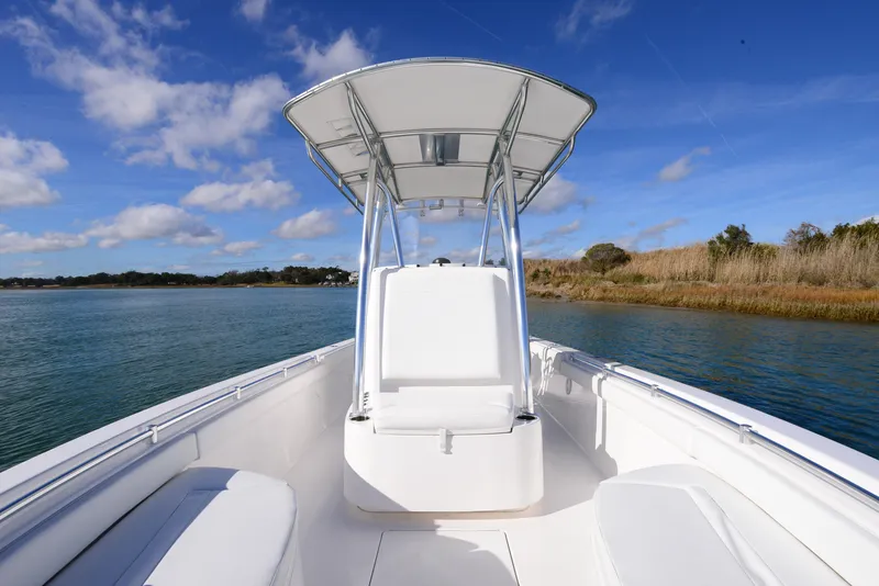 Slide: The Image of 2024 Contender 24 Sport boat on calm water under blue sky. - 18
