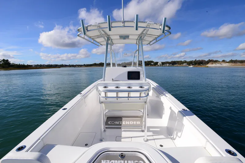Slide: The Image of 2024 Contender 24 Sport boat on calm water under blue sky. - 19