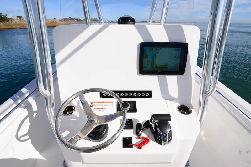Slide: The Image of 2024 Contender 24 Sport boat console with steering wheel and navigation screen. - 20