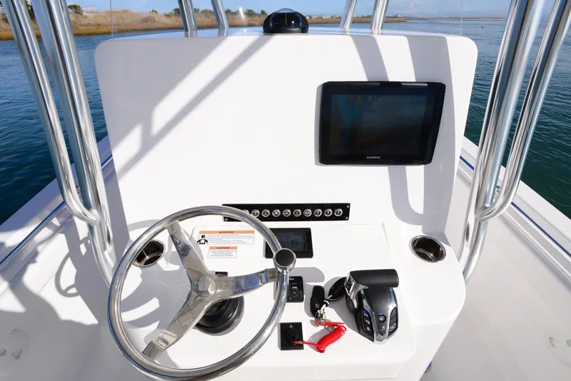 Slide: The Image of 2024 Contender 24 Sport boat console with steering wheel and navigation screen. - 21