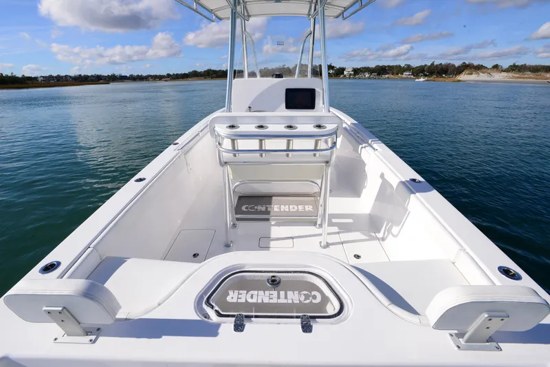Slide: The Image of 2024 Contender 24 Sport boat on calm water, showcasing spacious deck and seating. - 22