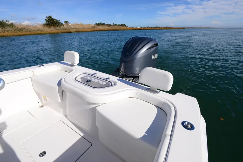 Slide: The Image of 2024 Contender 24 Sport boat with Yamaha engine on calm water. - 24