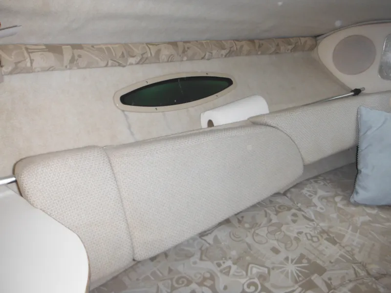 Slide: The Image of Interior cabin of 2004 Sea Ray 215 Weekender boat with cushioned seating. - 28