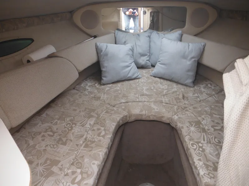 Slide: The Image of 2004 Sea Ray 215 Weekender cabin interior with cushions and patterned upholstery. - 30