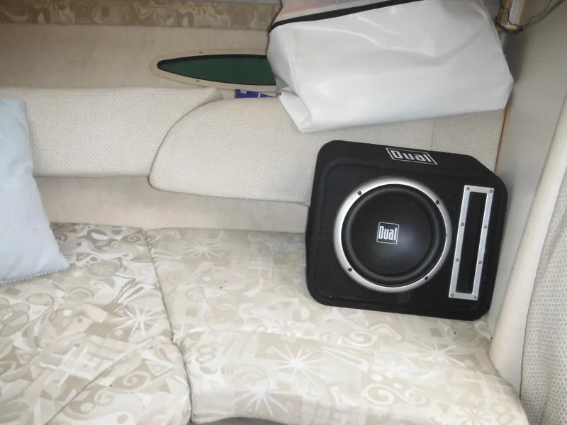 Slide: The Image of Interior of 2004 Sea Ray 215 Weekender with Dual subwoofer on patterned seating. - 32