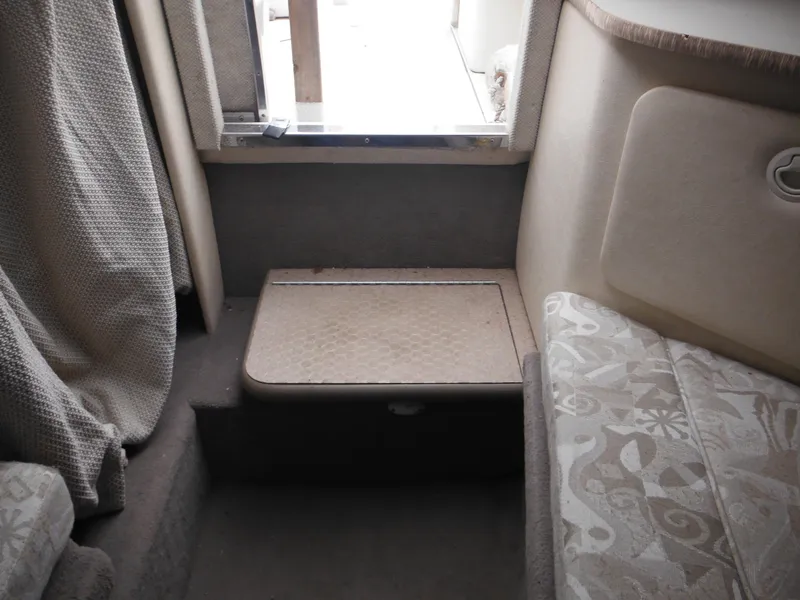 Slide: The Image of Interior cabin of 2004 Sea Ray 215 Weekender boat, featuring seating and storage. - 33