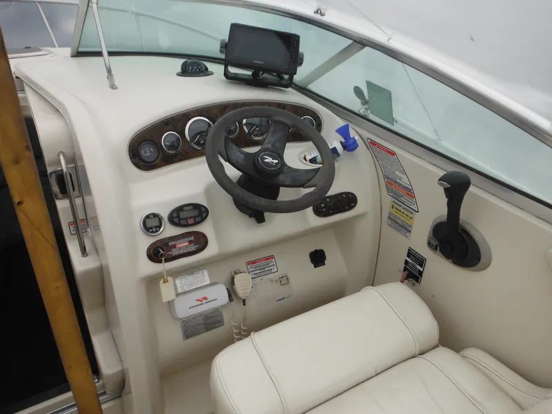 Slide: The Image of Interior cockpit of 2004 Sea Ray 215 Weekender boat with steering wheel and controls. - 38