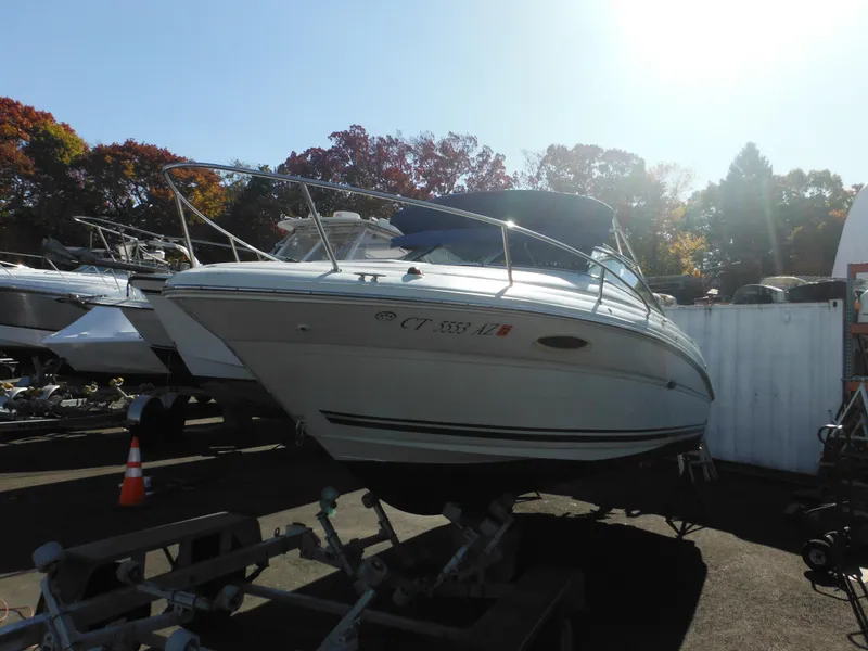 Slide: The Image of 2004 Sea Ray 215 Weekender boat on trailer in sunny outdoor setting. - 4