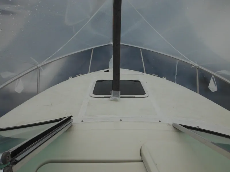 Slide: The Image of 2004 Sea Ray 215 Weekender boat deck view with windshield and hatch. - 41