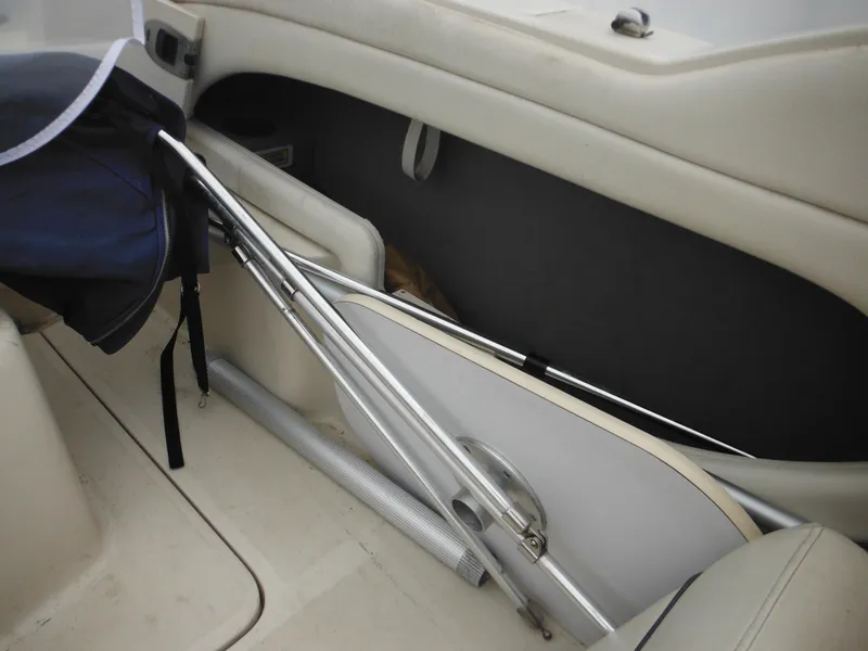 Slide: The Image of Interior of 2004 Sea Ray 215 Weekender boat with folded equipment storage. - 43