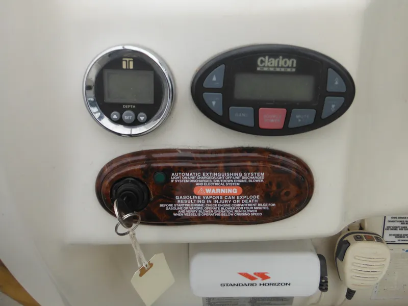 Slide: The Image of Control panel of 2004 Sea Ray 215 Weekender with depth gauge and Clarion audio system. - 44