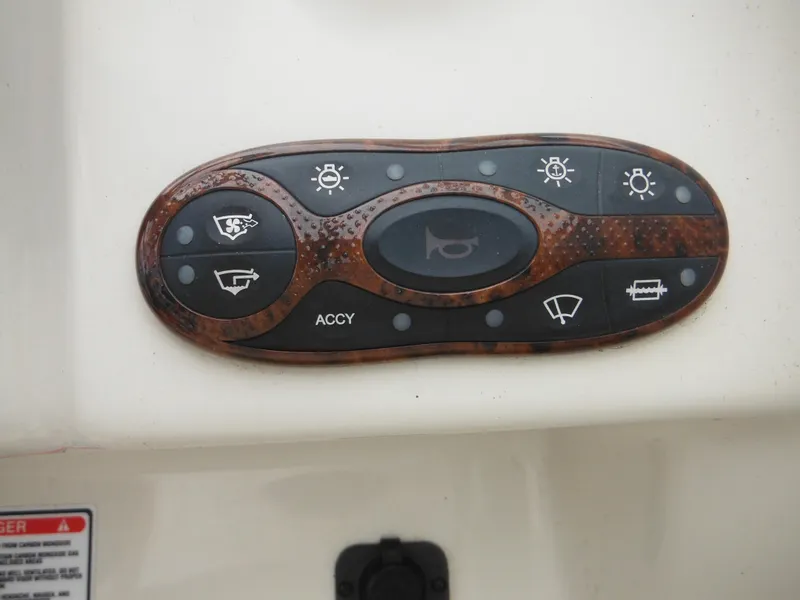 Slide: The Image of Control panel of 2004 Sea Ray 215 Weekender boat with various function buttons. - 46