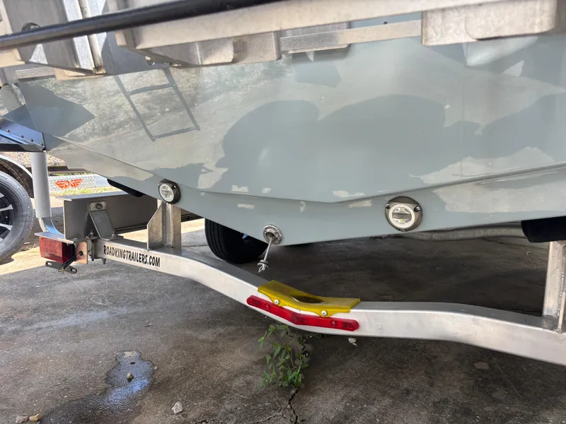 Slide: The Image of 2025 KenCraft 269 boat on trailer, showcasing hull and trailer details. - 16