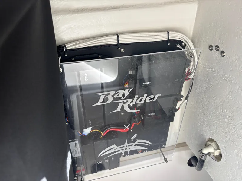 Slide: The Image of KenCraft 269 Bay Rider 2025 boat wiring panel with visible cables and components. - 18