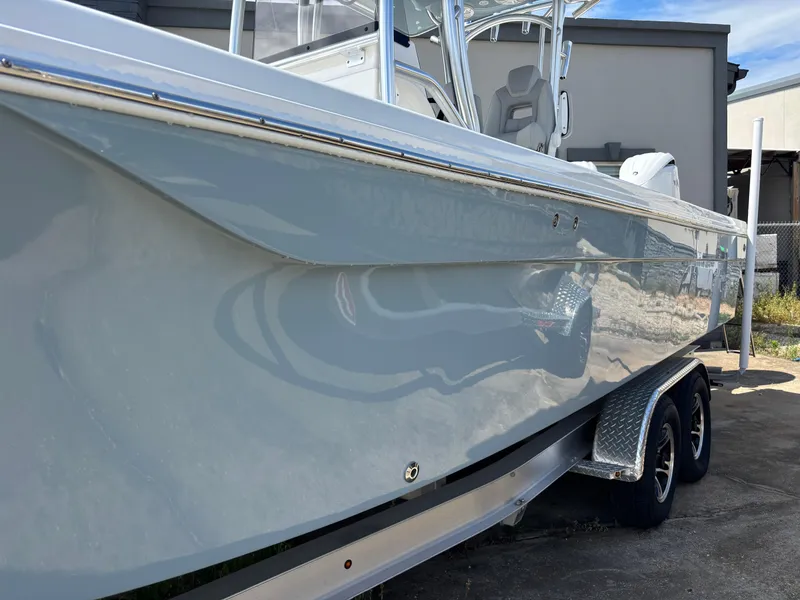 Slide: The Image of 2025 KenCraft 269 boat with sleek design and dual-axle trailer. - 19