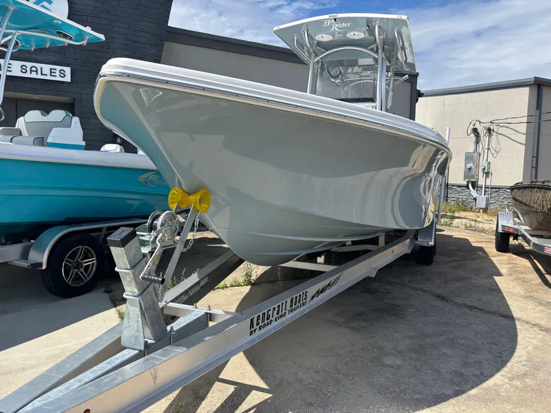 Slide: The Image of 2025 KenCraft 269 boat on trailer, displayed outdoors at a sales location. - 21