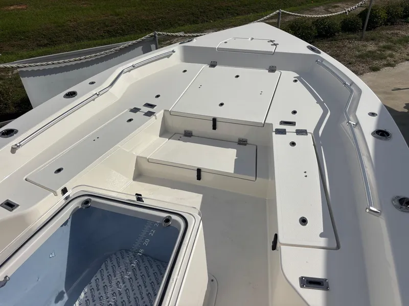 Slide: The Image of 2025 KenCraft 269 boat deck with storage compartments and seating area. - 23