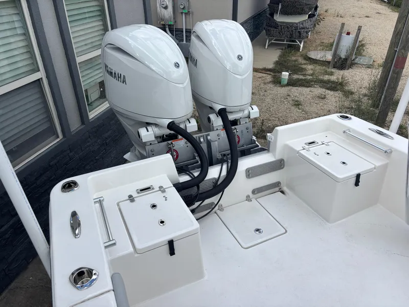 Slide: The Image of 2025 KenCraft 269 boat deck, featuring a spacious, clean white surface with storage compartments. - 26