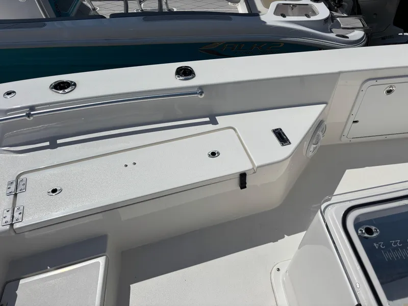 Slide: The Image of 2025 KenCraft 269 boat deck with storage compartments and fishing rod holders. - 29