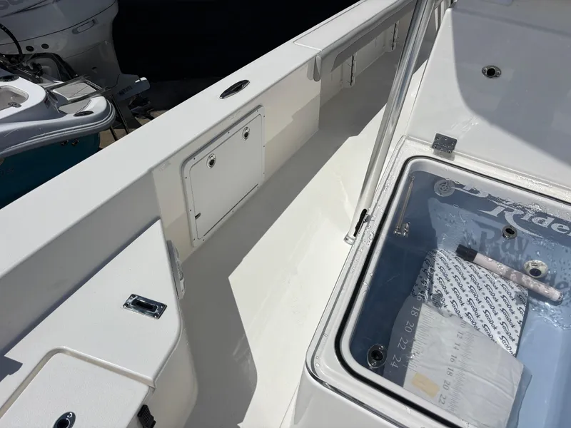 Slide: The Image of 2025 KenCraft 269 boat interior with storage compartments and clear hatch. - 30
