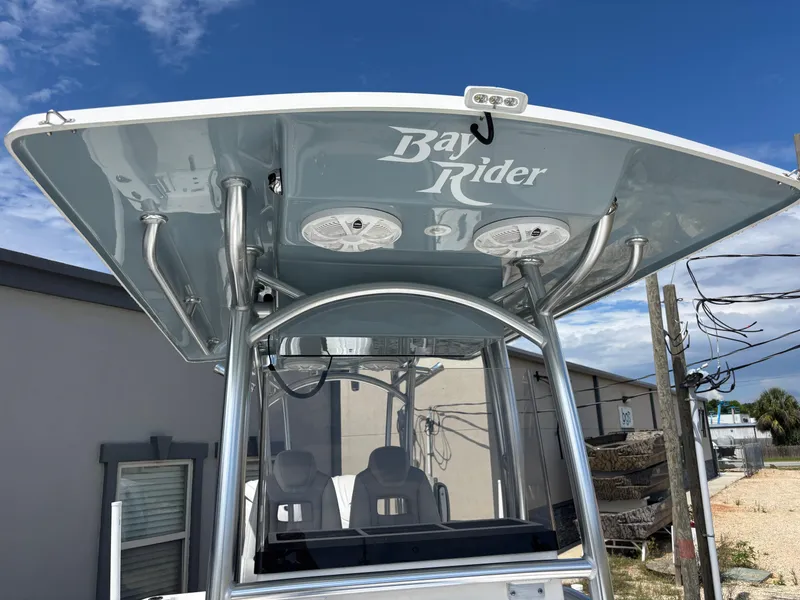 Slide: The Image of KenCraft 269 Bay Rider boat, 2025 model, featuring a sleek T-top design under a clear blue sky. - 32