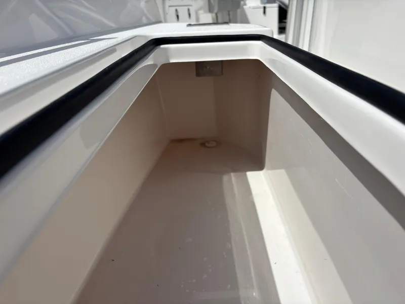 Slide: The Image of Storage compartment of 2025 KenCraft 269 boat, featuring sleek white interior design. - 37