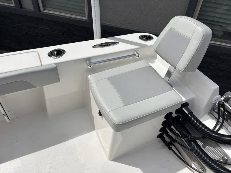 Slide: The Image of 2025 KenCraft 269 boat seating area with gray cushioned seat and rod holders. - 43