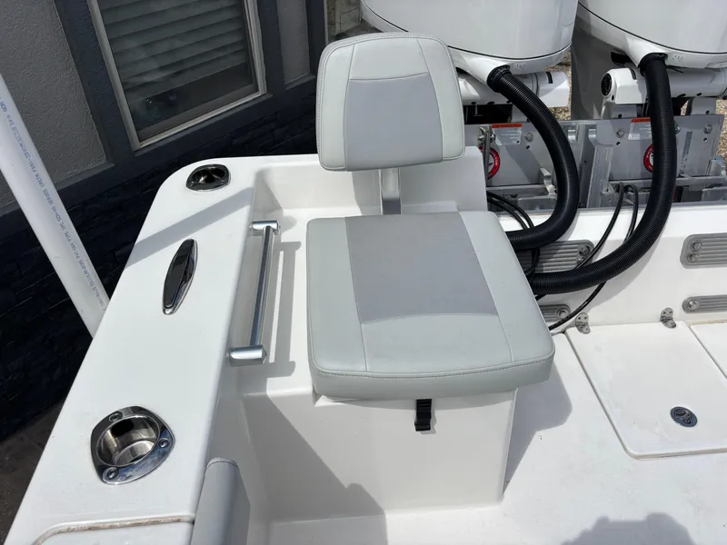 Slide: The Image of KenCraft 269 boat seat, 2025 model, with cup holders and engine cables visible. - 44