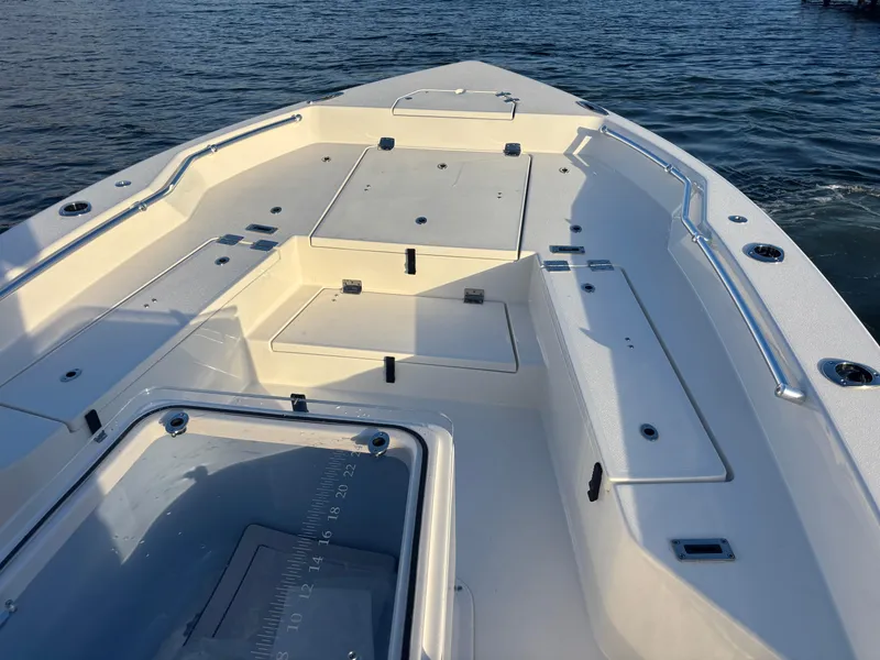 Slide: The Image of 2025 KenCraft 269 boat deck with storage compartments on calm water. - 5