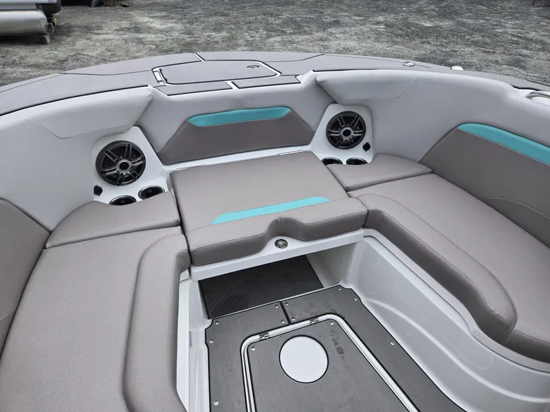 Slide: The Image of 2025 Hurricane Center Console 24 OB boat interior with gray seating and teal accents. - 13