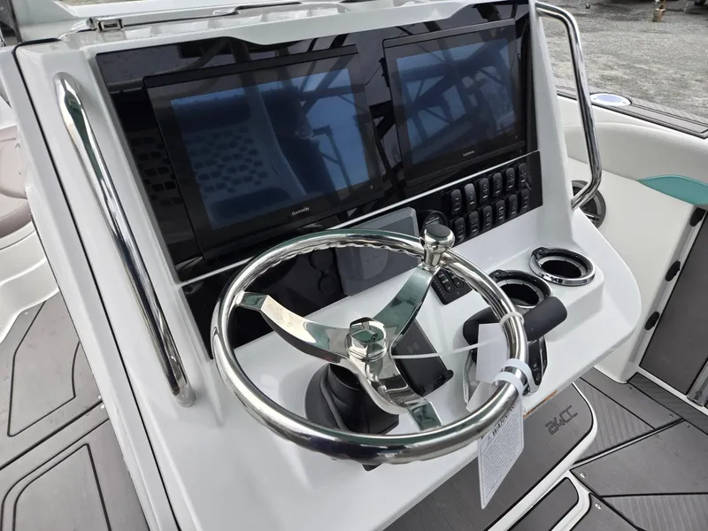 Slide: The Image of 2025 Hurricane Center Console 24 OB helm with dual screens and modern steering wheel. - 18
