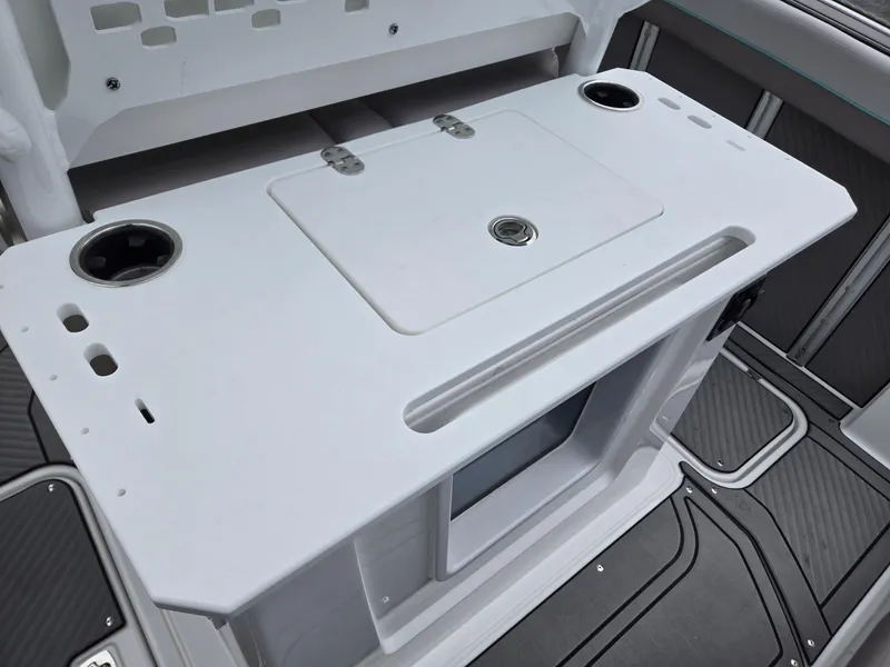 Slide: The Image of 2025 Hurricane Center Console 24 OB boat interior with storage and cup holders. - 25