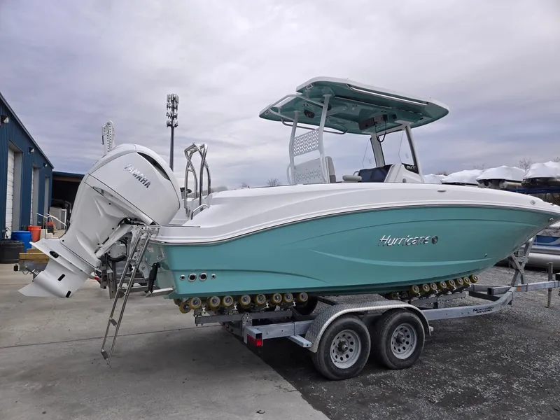 Slide: The Image of 2025 Hurricane Center Console 24 OB boat on trailer, featuring sleek design and Yamaha outboard motor. - 3