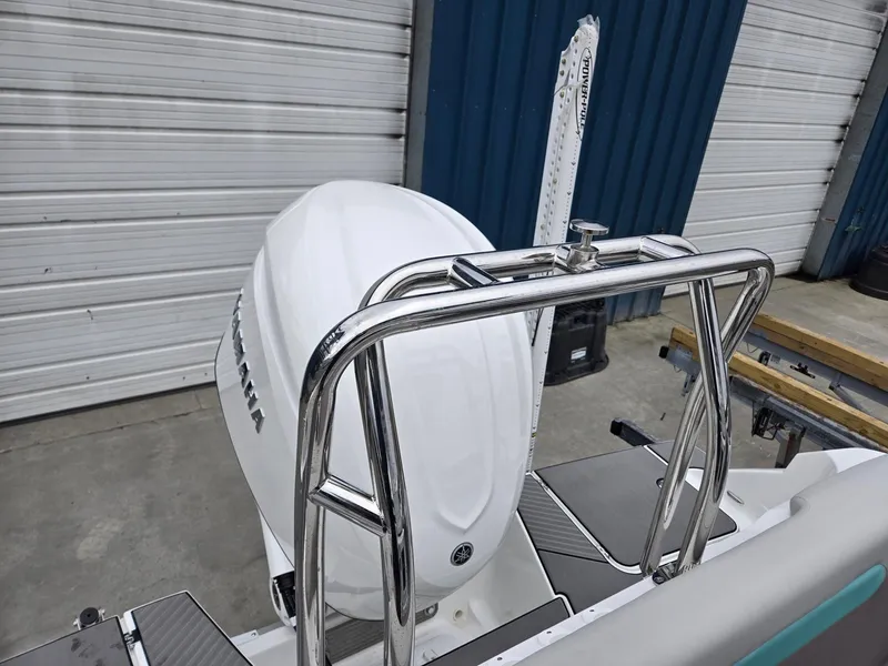 Slide: The Image of 2025 Hurricane Center Console 24 OB with Yamaha outboard motor, docked near storage facility. - 33