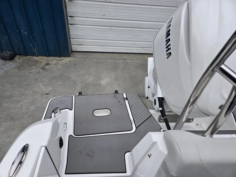 Slide: The Image of 2025 Hurricane Center Console 24 OB boat with Yamaha engine, docked on concrete surface. - 34