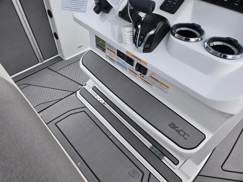 Slide: The Image of 2025 Hurricane Center Console 24 OB boat interior with controls and cup holders. - 36