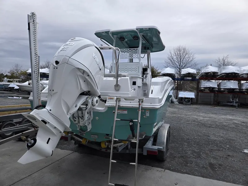 Slide: The Image of 2025 Hurricane Center Console 24 OB boat on trailer, featuring a powerful outboard motor. - 4