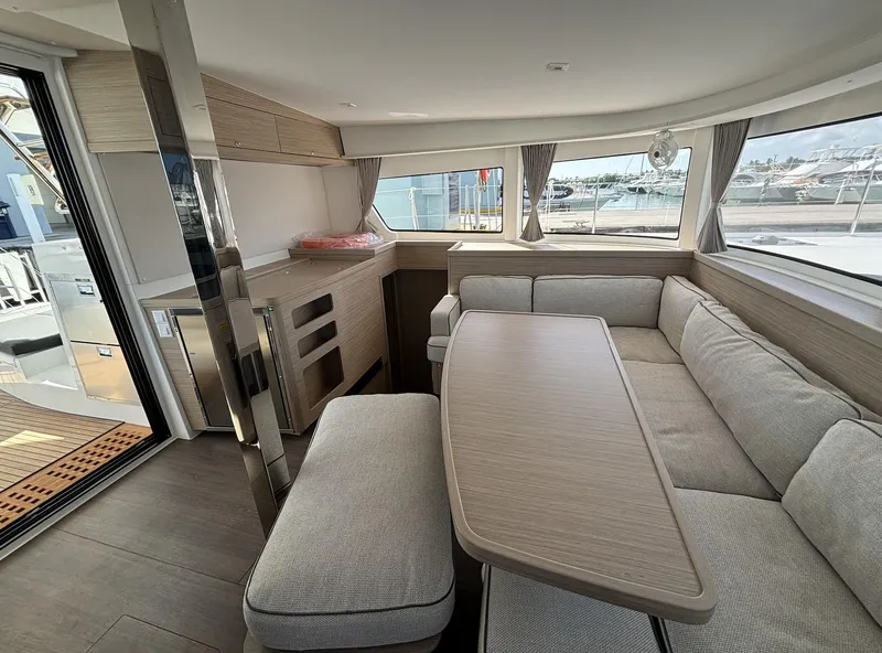 Slide: The Image of Interior of 2025 Lagoon 42 yacht with modern seating and dining area. - 12