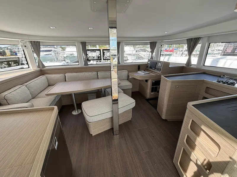Slide: The Image of Spacious interior of 2025 Lagoon 42 catamaran with modern furnishings and ample seating. - 13