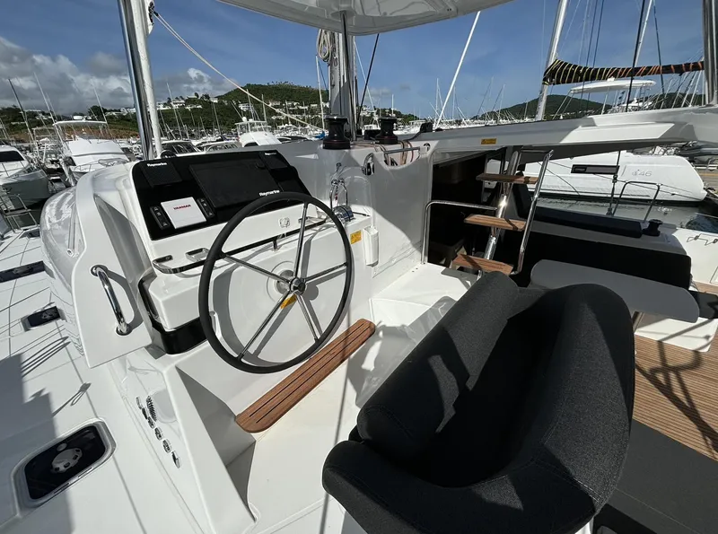 Slide: The Image of 2025 Lagoon 42 yacht cockpit with steering wheel and navigation controls. - 19