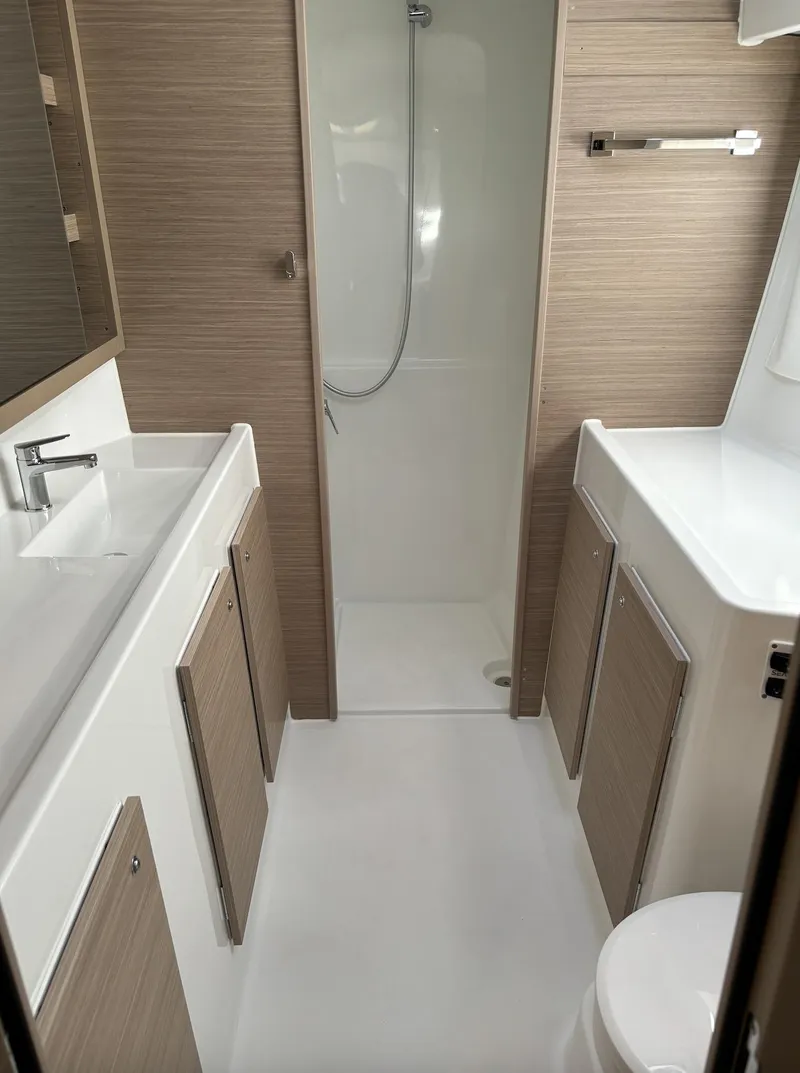 Slide: The Image of Modern bathroom in 2025 Lagoon 42 yacht with sleek design and wood accents. - 25